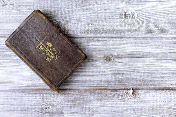 Old ancient antique catholic bible on wooden background with copy space. - Fotografie, Obrázek