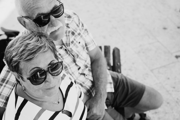 Mature couple resting in park on summer day - Photo, Image