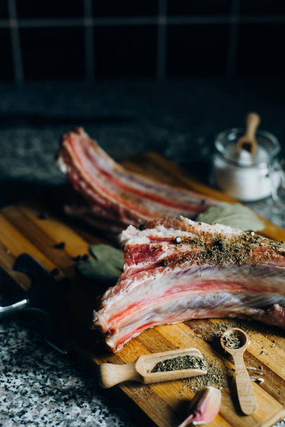  raw meat on wooden cutting board on dark background - Fotografie, Obrázek