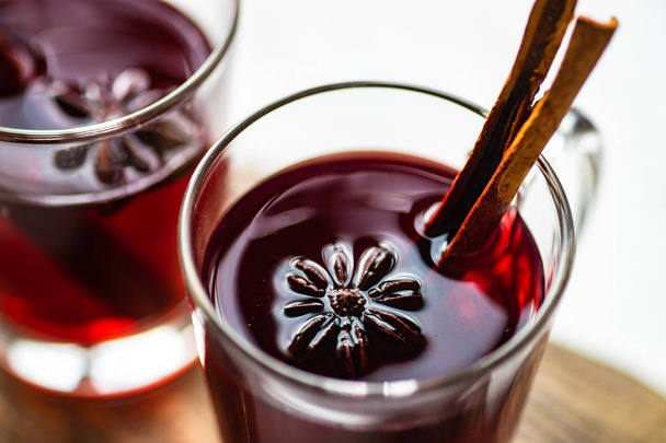 Traditional winter drink  mulled wine and Christmas decorations on white rustic background - Photo, Image