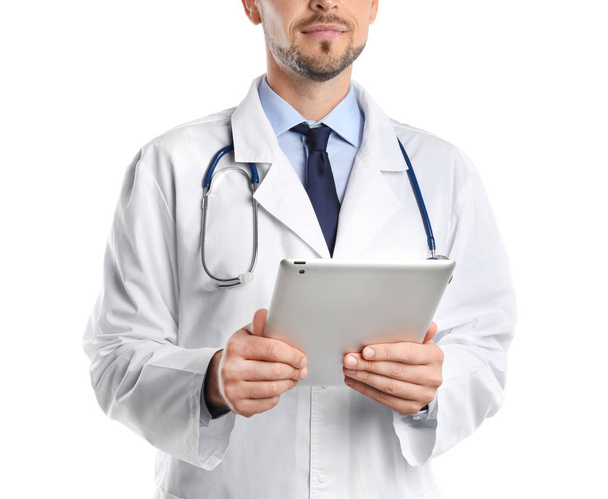 Male doctor holding modern tablet on white background, closeup - Foto, imagen