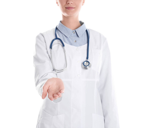 Female doctor offering helping hand on white background, closeup - Valokuva, kuva