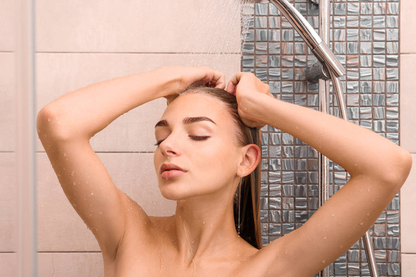 Beautiful young woman taking shower at home - Valokuva, kuva
