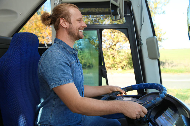 Professional bus driver at steering wheel. Passenger transportation - Foto, Bild