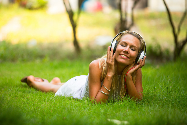Happiness emotional girl with headphones enjoying nature and music at sunny day. - Photo, Image