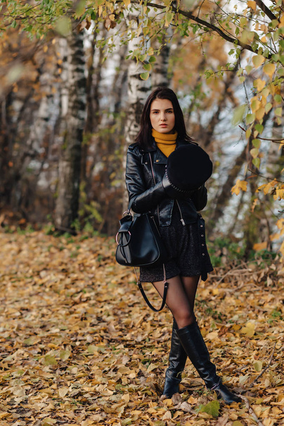 cozy stylish young girl walk at autumn colorful park alone make photos - Fotoğraf, Görsel
