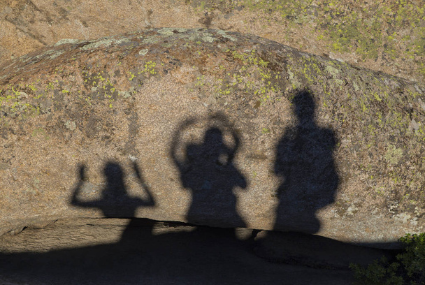 Shadows of happy people on the rocks - Photo, Image