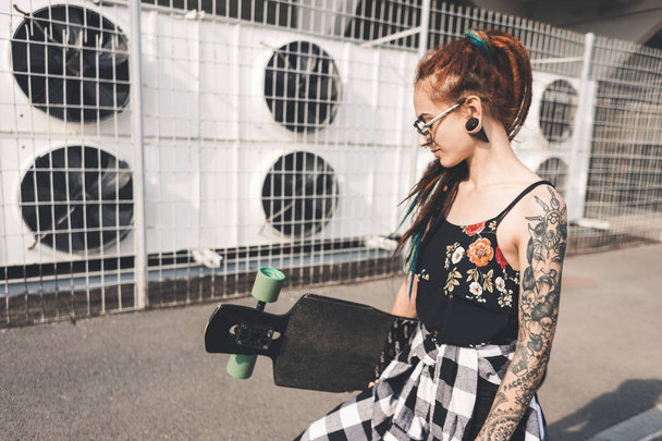 young girl with tattoo and dreadlocks on urban industrial background - Zdjęcie, obraz