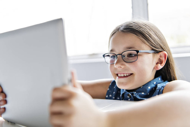 A cute Child using tablet at school - Foto, Imagem