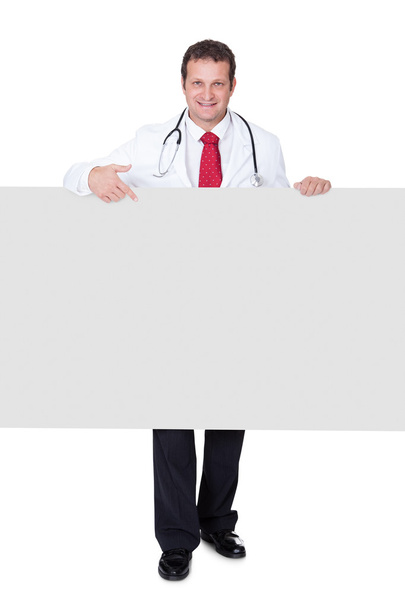 Confident doctor presenting empty banner - Foto, immagini