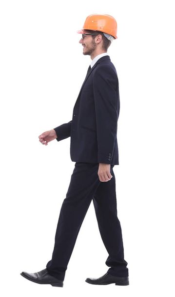 businessman in a protective helmet, stepping forward - Фото, зображення