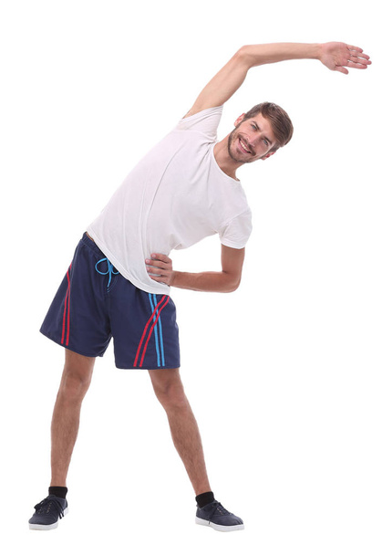 in full growth.smiling man performs morning exercises - Foto, afbeelding