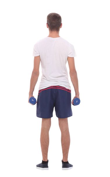 rear view.young man with dumbbells - Фото, зображення