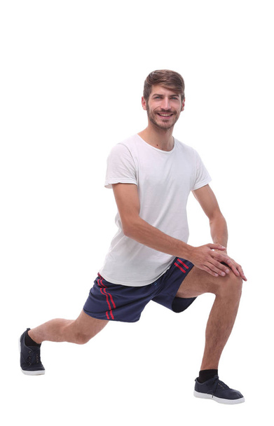 Full length.active mâle effectue squats avec les bras droits
. - Photo, image