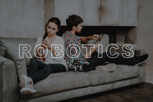 Leisure Time. Unhappy. Ignores. Play. Couch. Hugs. Living Room. Young Couple. Collect. Robots. Guy. Work Together. Girl. Smiling. Beautiful. Have Fun. Family. Designing Robots. Home. Happiness. - Photo, Image