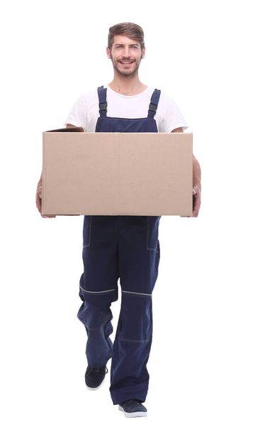 in full growth.a man carries a large cardboard box - Φωτογραφία, εικόνα