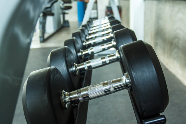 Sports dumbbells in modern sports club. Weight Training Equipment - Photo, Image