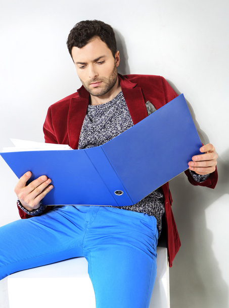 Portrait of businessman with a blue folder of documents - Fotoğraf, Görsel