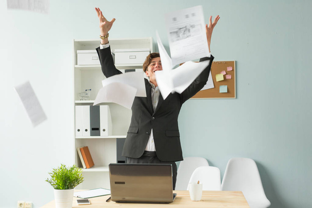 Business people, joke and fun concept - happy funny businessman throwing papers in office - Fotó, kép