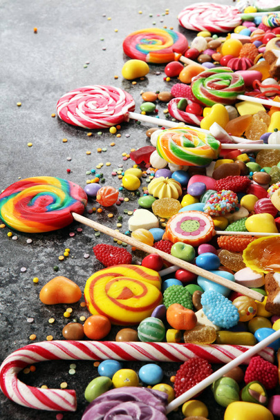 candies with jelly and sugar. colorful array of different childs sweets and treats - Photo, Image