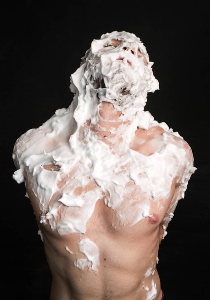 photo portrait of a muscular guy smeared with shaving foam - Photo, Image