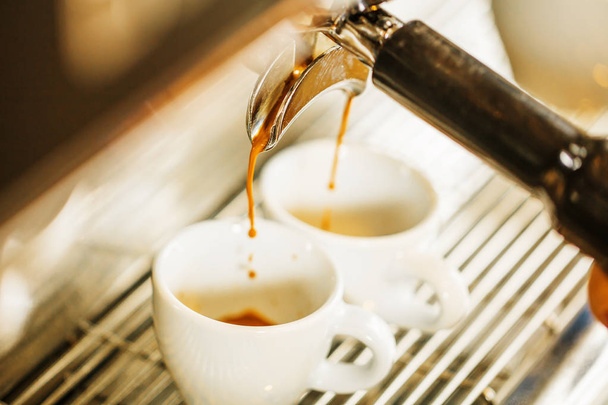 Close-up of espresso pouring from coffee machine. Professional coffee brewing - Photo, image