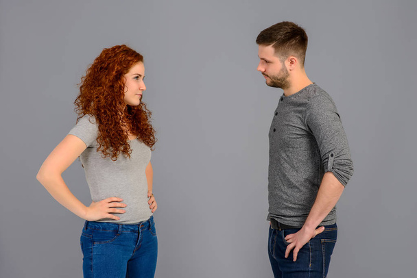 A beautiful young couple standing and arguing in the studio - Photo, Image