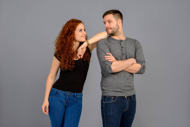 A beautiful young couple standing in the studio confidently - Photo, Image