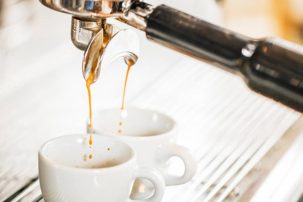 Close-up of espresso pouring from coffee machine. Professional coffee brewing - Foto, Imagen