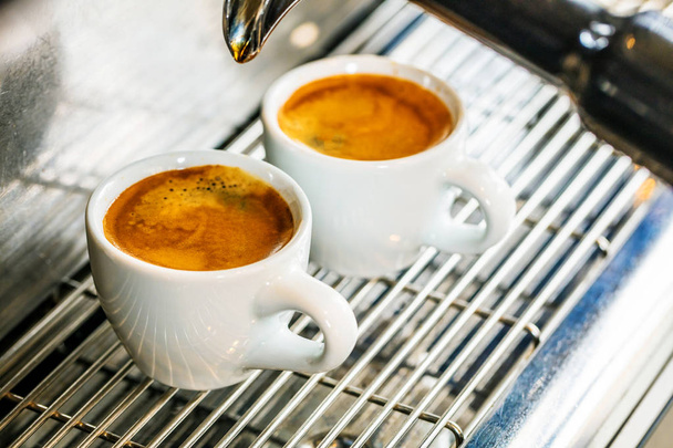 Close-up of espresso pouring from coffee machine. Professional coffee brewing - Foto, afbeelding