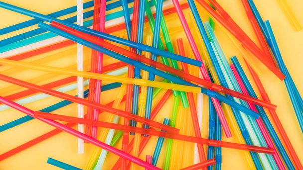 Drinking straws for colored background. Colorful plastic straws used for drinking water or soft drinks - Photo, Image