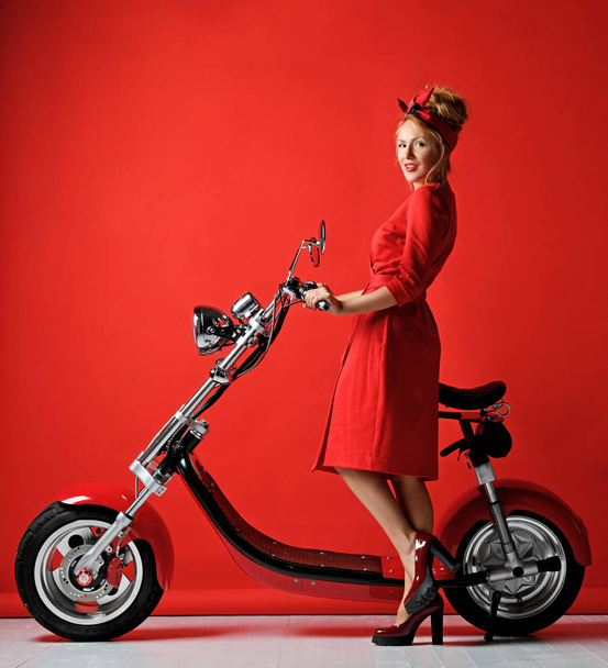 Woman pinup style ride new electric car motorcycle bicycle scooter present for new year 2019 - Photo, image