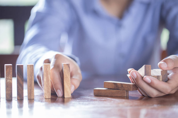 Playing dominoes on a wooden table. Man's hand with dominoes. - Foto, Imagem