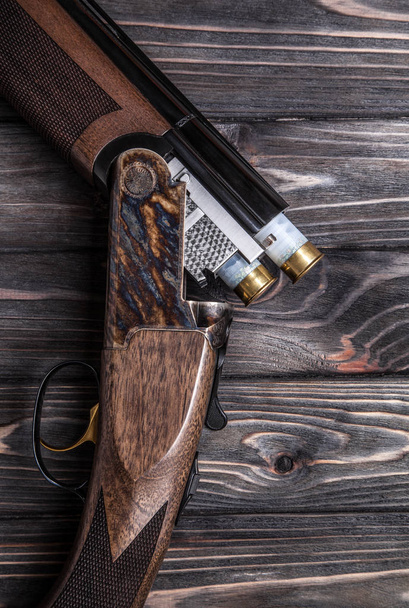 open wooden hunting rifle on a wooden background - Foto, Imagem