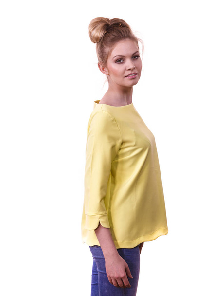 Adult woman presenting her casual beautiful outfit, long sleeved yellow top and jeans. - Foto, afbeelding