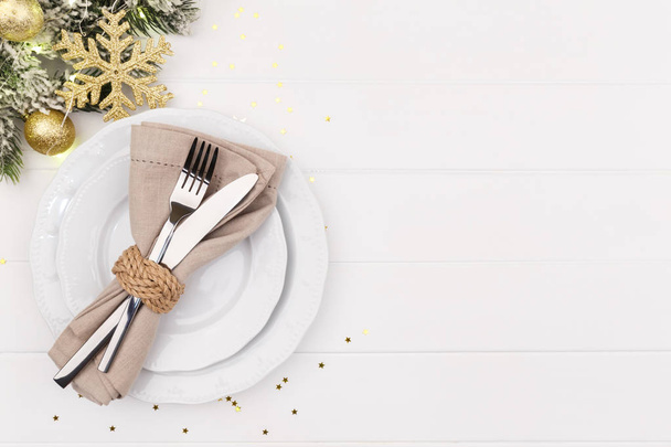 Christmas or new year table setting on white wooden table card or menu template copy space flat lay - Foto, imagen