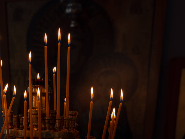 Votive candles alight in Greek Orthodox Church - Fotó, kép