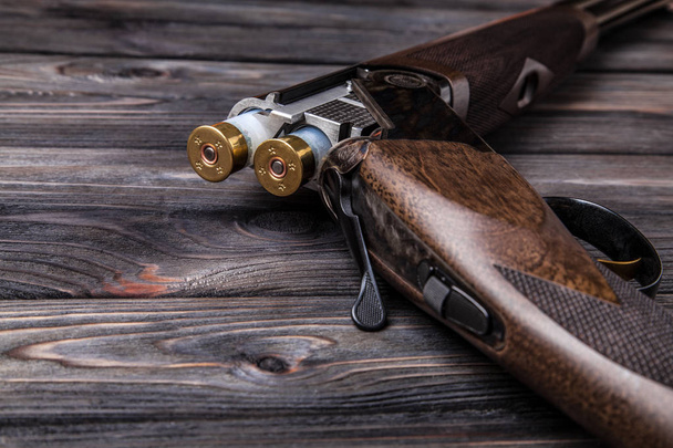 open wooden hunting rifle on a wooden background - Fotografie, Obrázek