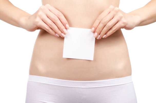 Woman health female body holding white card near stomach healthy - Foto, Imagen