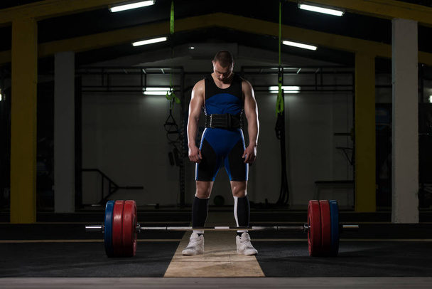 Powerlifter Stands in Front of the Barbel and Preparing for Deadlift - Photo, Image