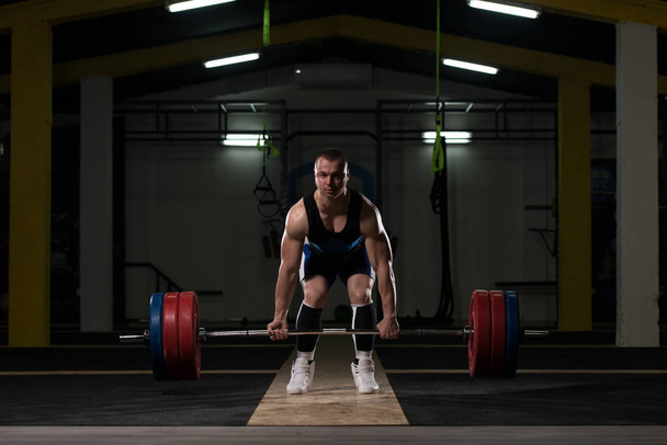 Professional Athlete Bent Over the Barbell and Is Preparing to Lift a Very Heavy Weight - Photo, image
