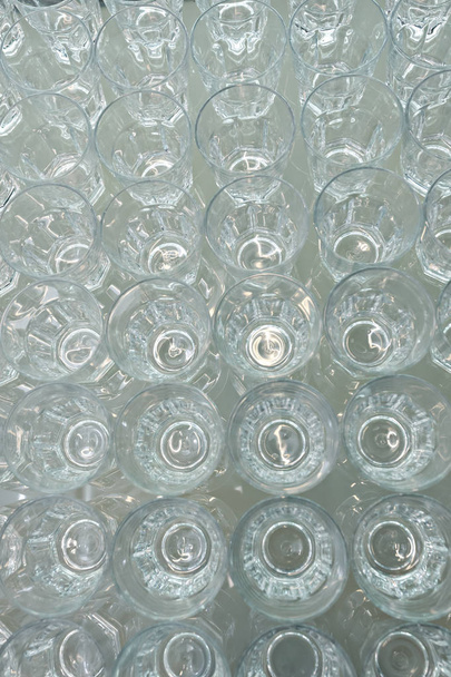 Group of clean empty transparent glasses rows directly above - Photo, Image