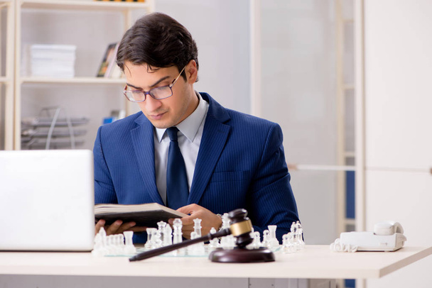 Young lawyer playing chess to train his court strategy and tacti - Photo, Image