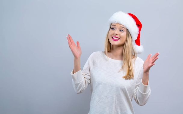 Happy woman with a Santa hat - Valokuva, kuva