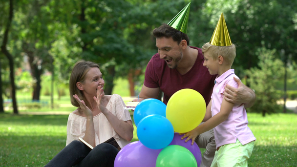 Father and son congratulate mom on birthday, pleasant surprise from parents - Filmmaterial, Video
