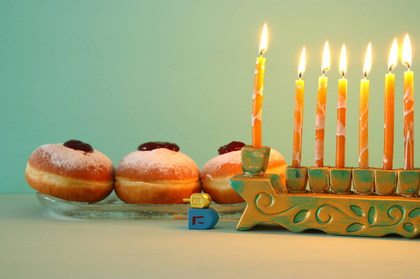image of jewish holiday Hanukkah background with menorah (traditional candelabra). Selective focus - Photo, image