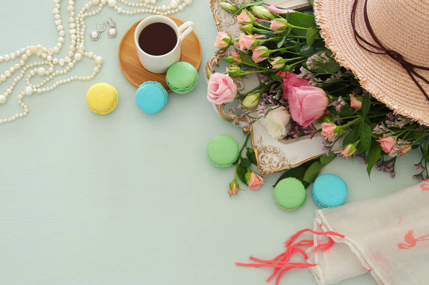 plate of macaroons over wooden table cofee and flowers - 写真・画像