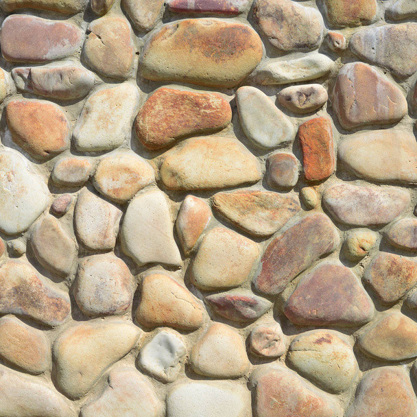 een fragment van een muur van een afgestoken steen in een achtergrondfoto. - Foto, afbeelding