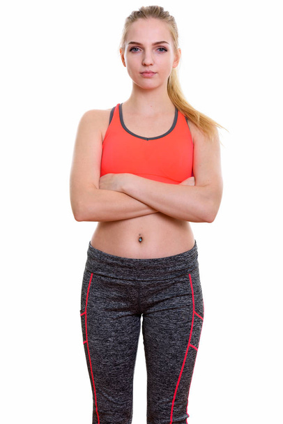Studio shot of young beautiful teenage girl standing with arms crossed ready for gym - Photo, Image