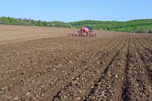 Kalush, Ukraine - April 14, 2016: Planting corn trailed planter in the field near the town of Kalush, Western Ukraine . - Photo, Image